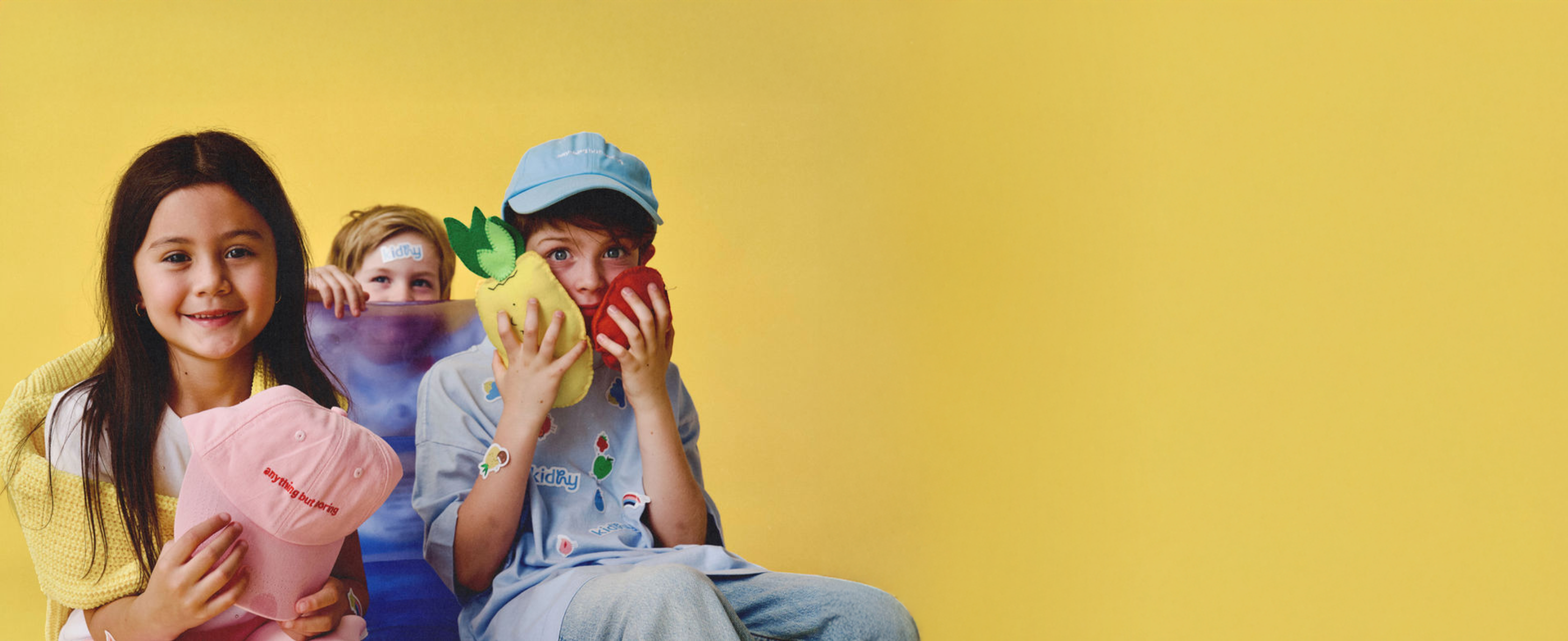 3 kids wearing kidhy caps playing with felt fruits, immune-boosting drinks for kids